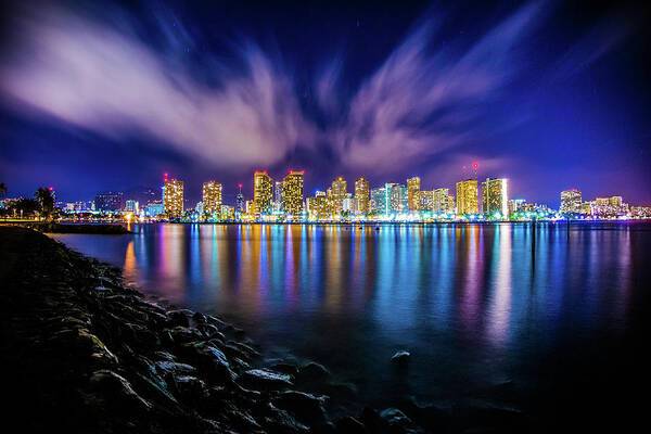 a city skyline is lit up at night