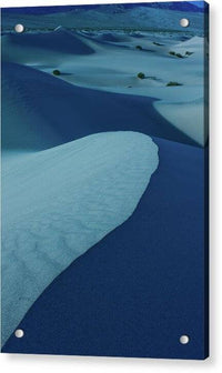 a snow covered field with a blue sky in the background