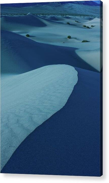 a large expanse of sand dunes covered in snow